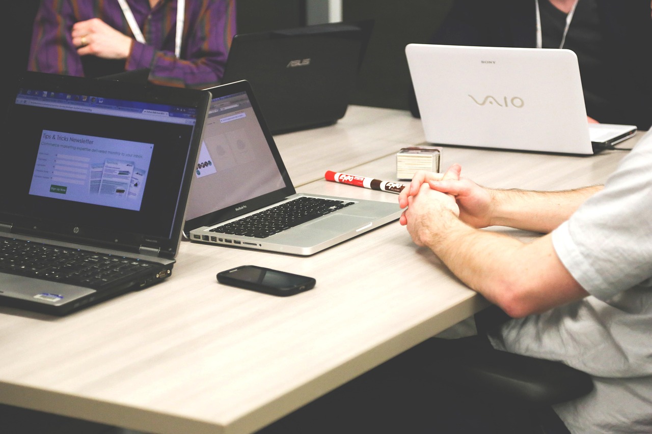 Laptops, meeting, businessmen — Bree Montoya: Leading With Integrity, Expertise, and Accountability