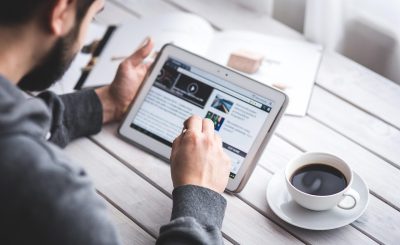 Man, reading, touchscreen — Mastering the Art of Rhinoplasty: Dr. P. Daniel Ward 's Pursuit of Precision and Perfection
