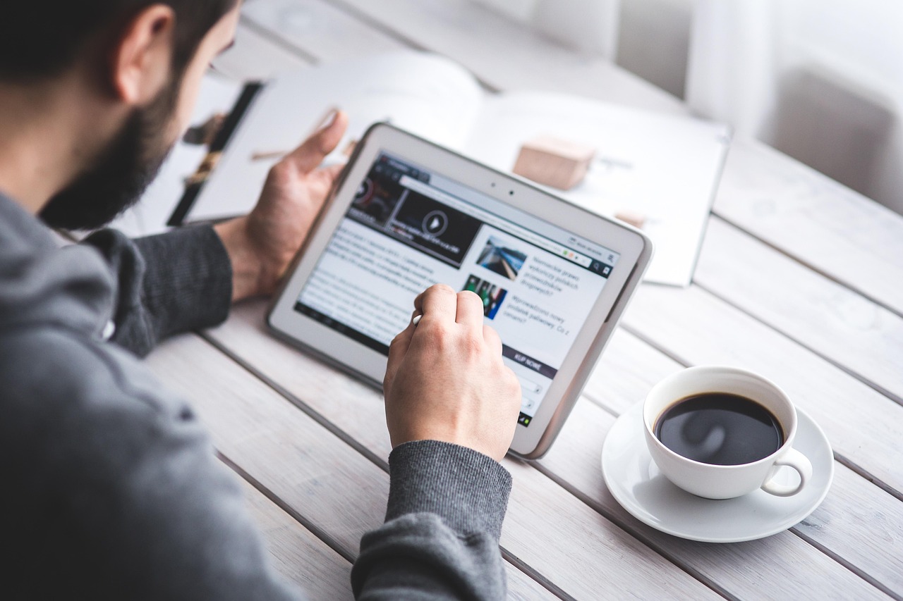 Man, reading, touchscreen — Mastering the Art of Rhinoplasty: Dr. P. Daniel Ward 's Pursuit of Precision and Perfection
